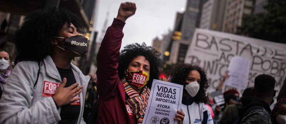 A woman raises her fist in the air during a protest in Rio de Janeiro. 