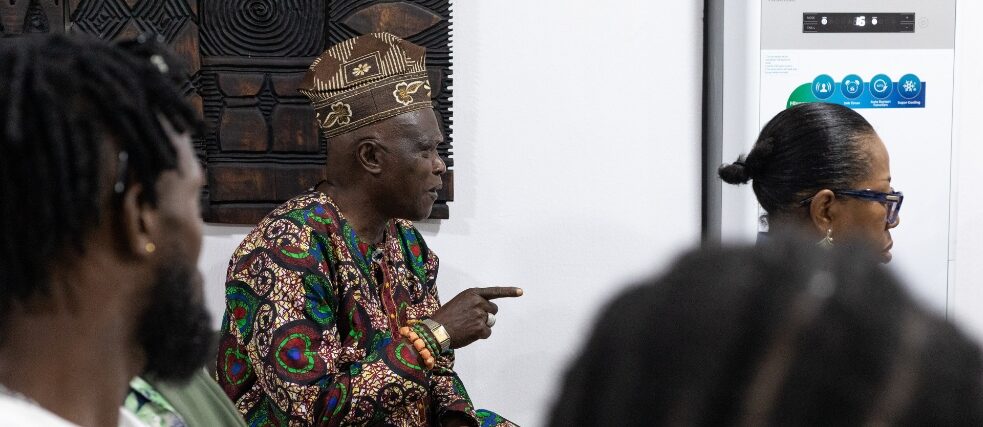 Man in traditional dress speaks in discussion