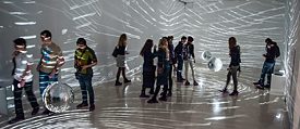 Visitors illuminated by Mischa Kuball’s light installation „spacespeechspeed“ in Perm.