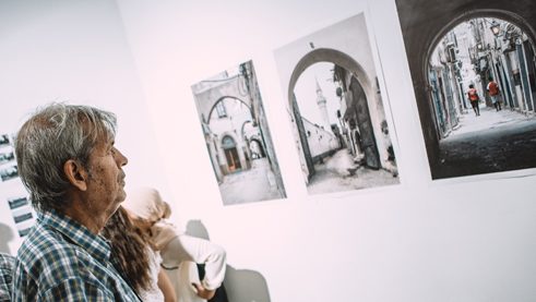Ein Besucher der Ausstellung „Portion of Libya“ vor Heba Alshibanis Fotos