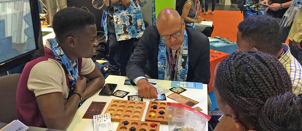 (Left to right): Moses Ayantunde (Lagos, Nigeria), Johannes Ebert, secretary-general of the Goethe-Institut, Kirubel Habtu (Addis Ababa, Ethiopia) and Adefoyeke Ajao (Lagos, Nigeria) playing the mega-game Busara launched at the Enter Africa stand of the Indie Arena Booth at gamescom