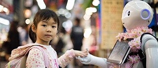 Child with robot at Kuromon Market in Osaka, Japan