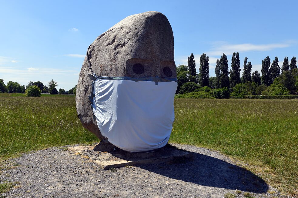 In tempi di pandemia di Covid-19, a questa testa di Joseph Beuys, realizzata nel 2008 da Anatol Herzfeld a Meerbusch-Büderich, qualcuno ha aggiunto una mascherina.