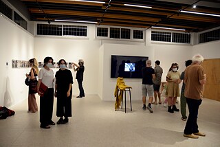 The curator Marina Christodoulidou looks at the exhibition in the room.