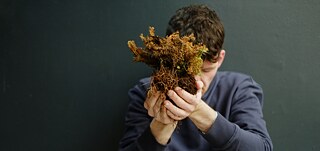 Man holding moss.