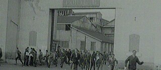 Archival image showing workers leaving the factory