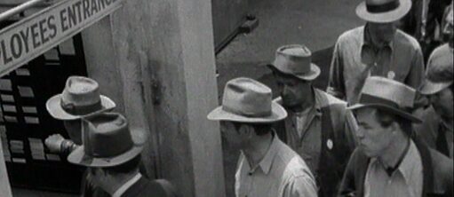 Archival film showing workers leaving the factory