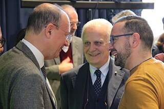 Giuseppe Valditara (Bildungsminister) und Mario Rusconi (ANP) im Gespräch mit einem Teilnehmer der Tagung 