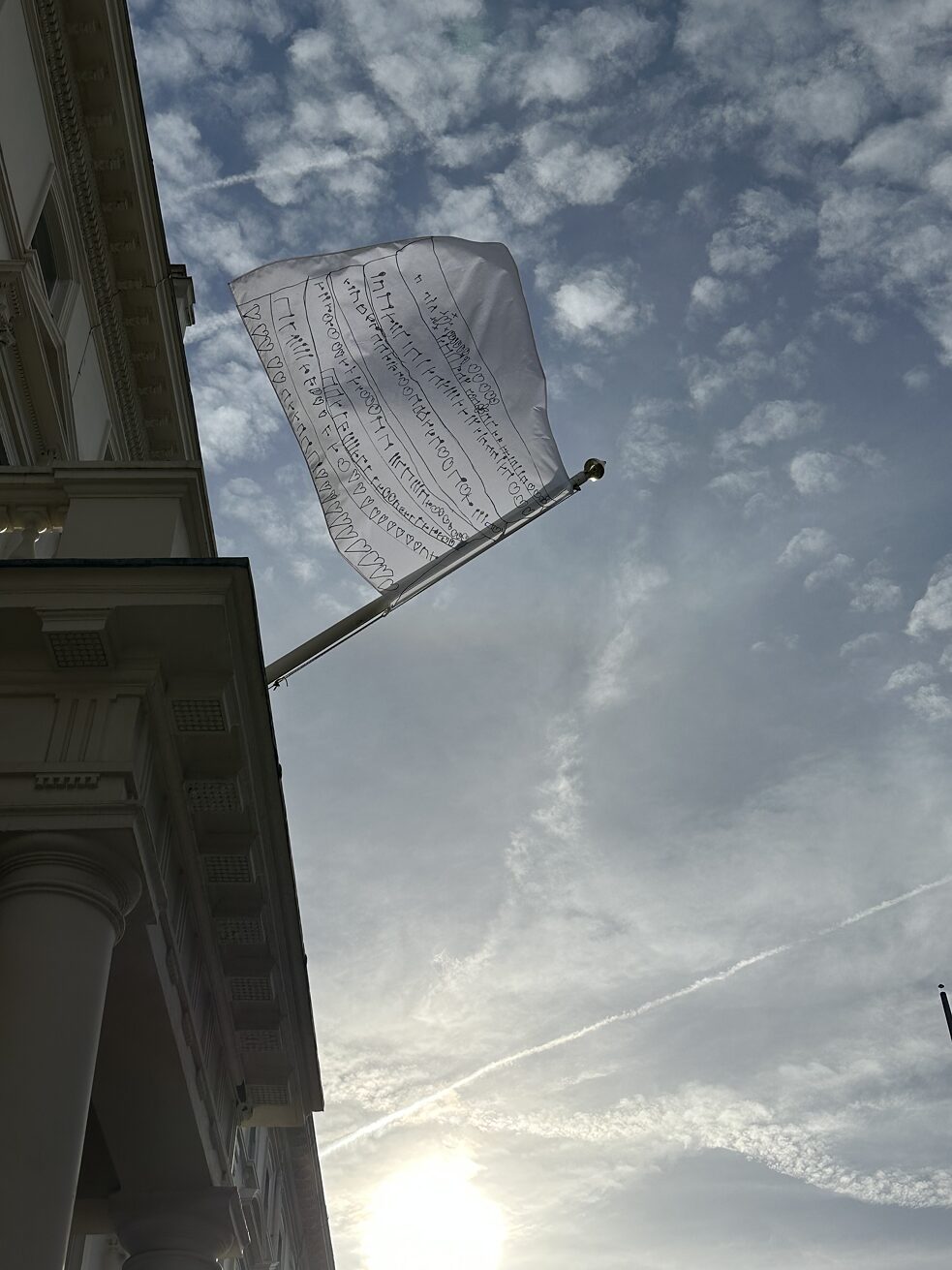 The flag hanging outside the Goethe-Institut London with cloudy sky 