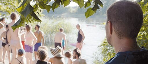 A man is looking at a group of bathers