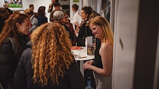 Visitors engage in a conversation after an event