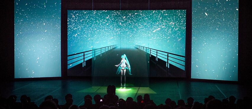 An image of an anime AI installation with audience in front 