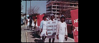 African American nurses in a protest march, one holds a sign saying "I am sick of tired of being sick and tired".