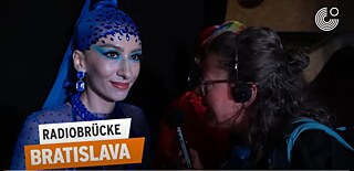 Radio Bridge Bratislava 2023 - Member of the queer community at the Ball of Shame with blue headgear