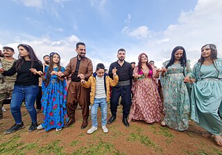 Syrian Kurds in their traditional outfits performing the Kurdish dabke in celebration of Newroz on March 21, Qamishli, Syria.