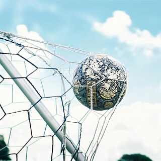 A football in the net of the goal