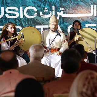 Mirzo Band in Mosul Heritage House on stage performing 