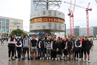 Підлітки стоять біля світового годинника в Берліні