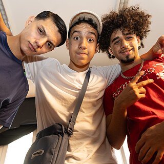 Three young men looking down into the camera