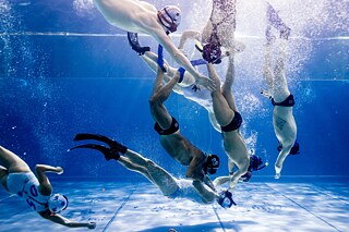 Two teams play underwater rugby