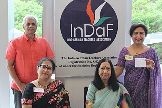 InDaF Team in front of InDaF Banner