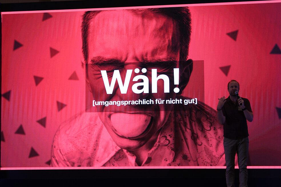 Prof. Dr. Thomas Strasser on stage in front of red screen