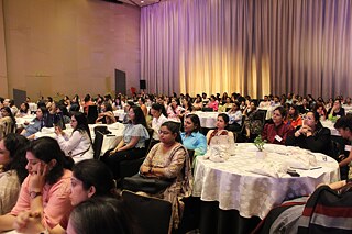 Teachers at tables in conference hall