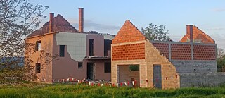 Photo is showing abandoned houses. 