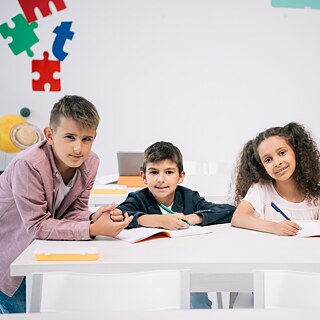 Four children sit at a table. 