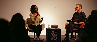 Sharon Dodua Otoo sits on the stage of the Goethe-Institut Sydney and is interviewed.