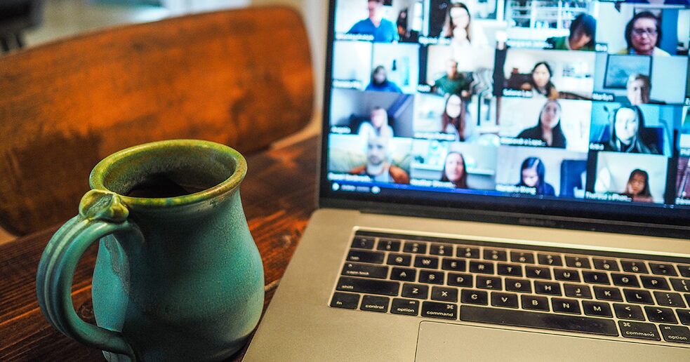 a coffee mug in front of a computer screen