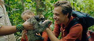 Checker Tobi with sloth in Brasilian rainforest