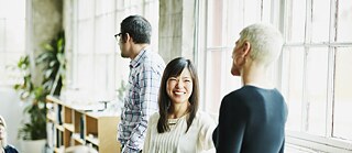  A group of people standing and actively participating in a discussion.