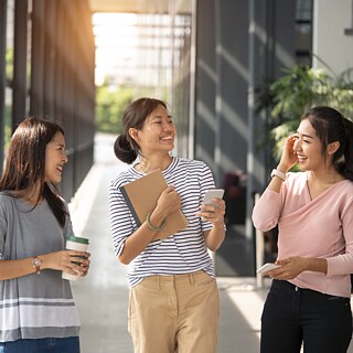 3 female friends standing in corridor