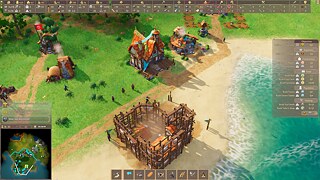 A  scene from the game "Pioneers of Pagonia" showing the surf of a body of water and the adjacent green land with houses and construction sites.