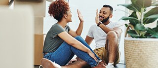 A smiling couple prepares for the move