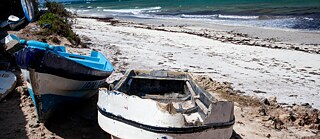 The broken and abandoned boats reflect the hardships faced by the Pemba fishermen. 