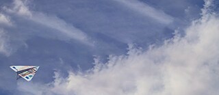 A paper airplane made from euro banknotes flies against a cloudy blue sky. © © Open AI / TheWhizKind Info Session - Blocked Account & Health Insurance