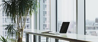 A laptop on a standing desk