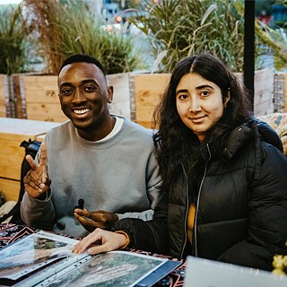 Two young people sitting over a working folder