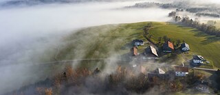 Agricultural landscape with farms rising out of the fog, Upper Austria