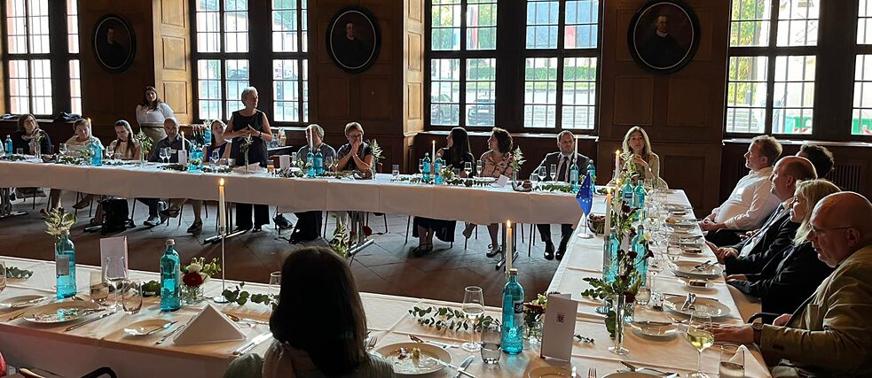 Alumni group in Eberbach Monastery having dinner together.