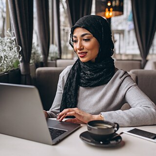 A young woman working on a laptop