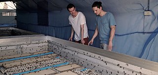 Timo Bäcker and Christopher Zeppenfeld, the founders of SWARM Protein, with one of their farmers in Thailand