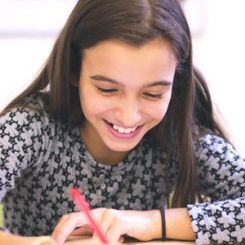 Young girl studying and laughing.