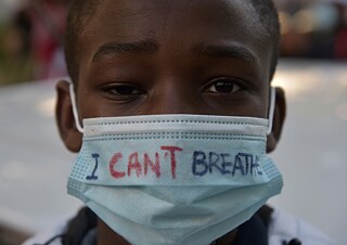 Racism – “I can't breathe” is written on the mask of a boy taking part in a rally against police violence in Frankfurt.