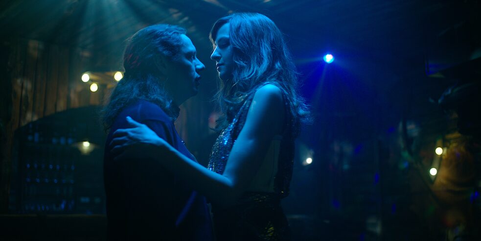 Daniel "Toothless" Sluiter (Christian Friedel) and Elena Seliger (Natalia Belitski) are dancing together on a dark dance floor, looking each other in the eye.