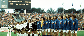 The teams of the Federal Republic of Germany and the GDR line up for the anthems in Hamburg's Volksparkstadion on 22 June 1974 before the group match of the World Cup.