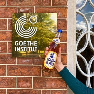 Club Mate Bottle in front of Goethe-Institut sign