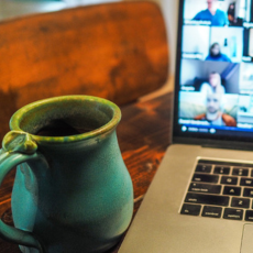 coffee mug in front of laptop